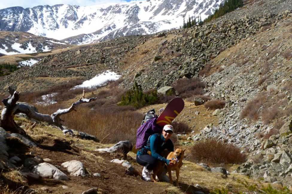 Kim Consantinesco with her dog on a mountainside